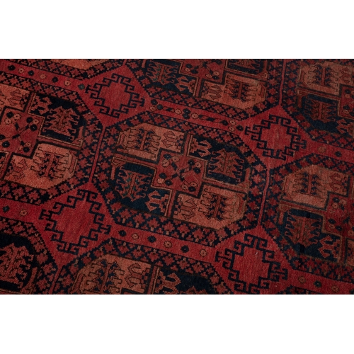 374 - A LARGE AFGHAN WOOL CARPET. 350 X 231CM    the shaded red field woven with three horizontal columns ... 