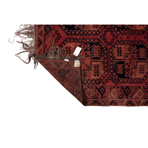 374 - A LARGE AFGHAN WOOL CARPET. 350 X 231CM    the shaded red field woven with three horizontal columns ... 