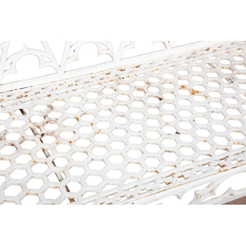 9 - A VICTORIAN WHITE PAINTED CAST IRON GARDEN BENCH  of Gothic design, the rectangular trellis back and... 