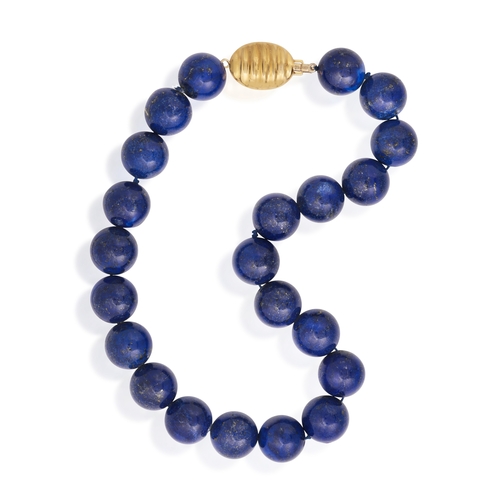 100 - A LAPIS LAZULI BEAD NECKLACE  Composed of a single strand of lapis lazuli beads measuring 18.4mm, to... 