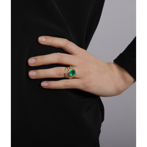 101 - AN EMERALD AND DIAMOND RING  Of oval-shape design, centring a collet-set oval-shaped emerald weighin... 