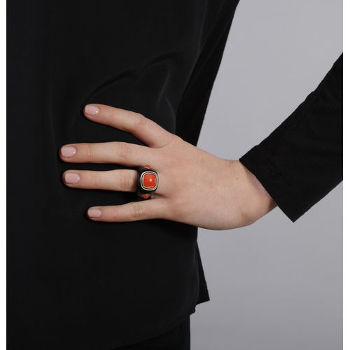 118 - SEAMAN SCHEPPS: A CORAL AND ONYX RING  The broad tapered ring mount composed of polished onyx, set w... 