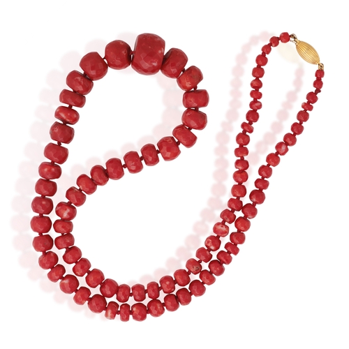 122 - A CORAL BEAD NECKLACE  Composed of a single strand of faceted graduated coral beads, to an oval-shap... 