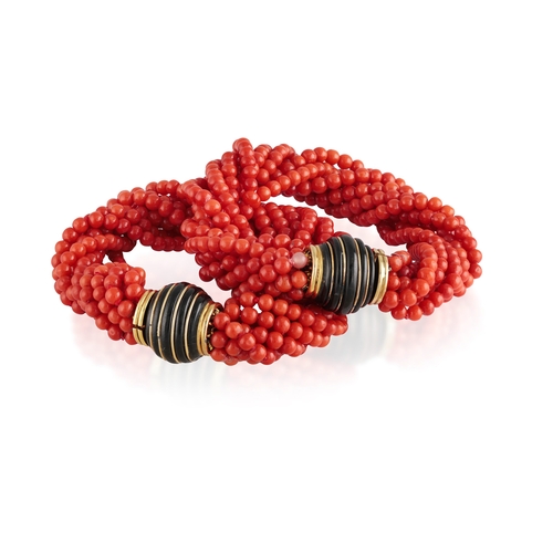 124 - TRIO: A CORAL AND ONYX NECKLACE/BRACELETS  Composed of eight strands of corallium rubrum coral beads... 