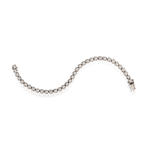 139 - A DIAMOND LINE BRACELET  Composed of a continuous row of fancy-shaped links, claw-set with brilliant... 