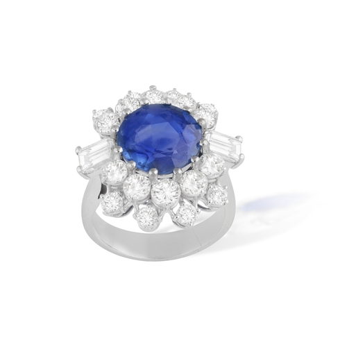 140 - A SAPPHIRE AND DIAMOND RING   Set with a circular-shaped sapphire, within a cluster surround of bril... 