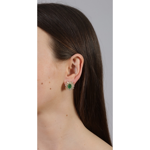 181 - A PAIR OF EMERALD AND DIAMOND EARRINGS  Each of cluster design, set with an oval-shaped emerald, wei... 