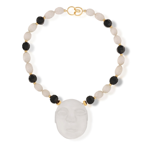 193 - A ROCK CRYSTAL AND ONYX PENDANT NECKLACE  Set with a large carved rock-crystal depicting a face, sus... 