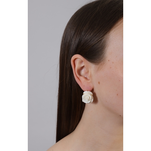 201 - A PAIR OF CORAL PENDENT EARRINGS  Each carved coral rose flowerhead, mounted in 18K gold, length 2.5... 