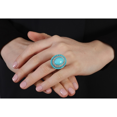 231 - A TURQUOISE AND DIAMOND COCKTAIL RING  Of oval-shaped design, centring an oval-shaped cabochon proba... 