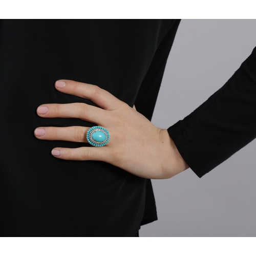 231 - A TURQUOISE AND DIAMOND COCKTAIL RING  Of oval-shaped design, centring an oval-shaped cabochon proba... 