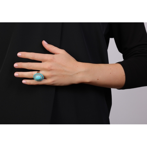 231 - A TURQUOISE AND DIAMOND COCKTAIL RING  Of oval-shaped design, centring an oval-shaped cabochon proba... 