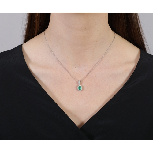 234 - AN EMERALD AND DIAMOND PENDANT NECKLACE   Set with an oval-shaped emerald weighing approximately 1.0... 