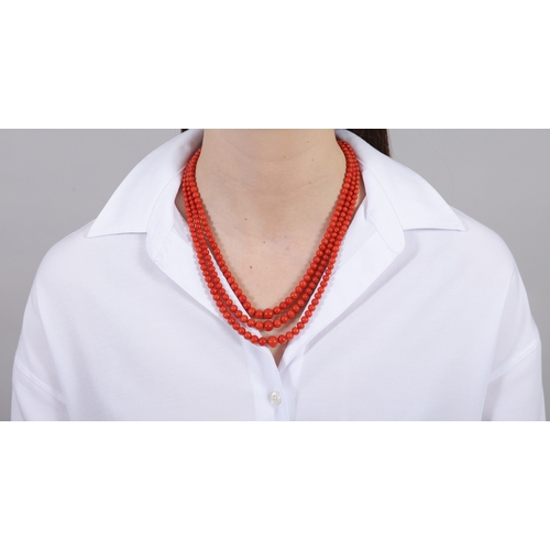 235 - A CORAL NECKLACE  Composed of three strands of graduated coral beads, measuring from 4.4 - 9.7mm, to... 