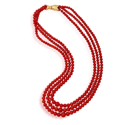 235 - A CORAL NECKLACE  Composed of three strands of graduated coral beads, measuring from 4.4 - 9.7mm, to... 