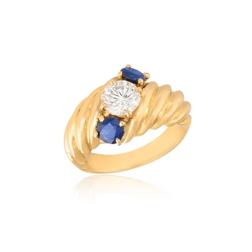 243A - A SAPPHIRE AND DIAMOND DRESS RING  Of reeded bombé design, centring a brilliant-cut diamond weighing... 