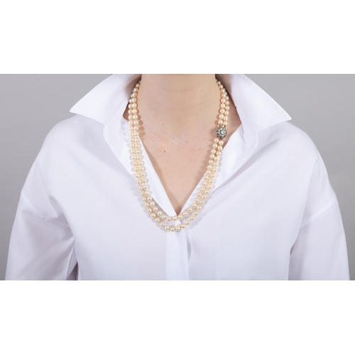 25 - A CULTURED PEARL AND DIAMOND NECKLACE  Composed of two strands of round-shaped cultured pearls of cr... 