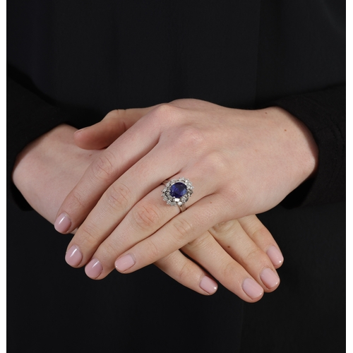 270 - A SAPPHIRE AND DIAMOND RING  Set with an oval-shaped sapphire weighing approximately 2.90cm, within ... 