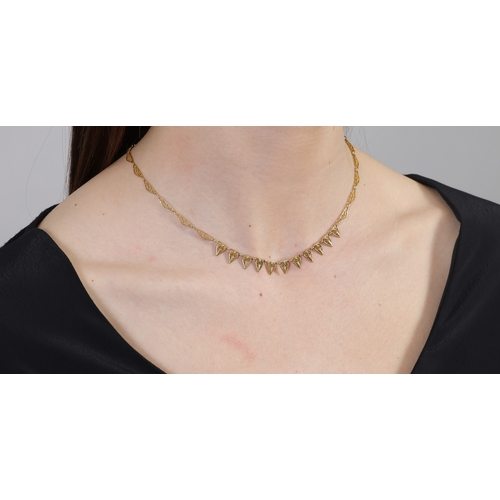 36 - AN EARLY 20TH CENTURY GOLD NECKLACE, FRENCH  The fancy-link chain with filigree detailing, in 18K go... 