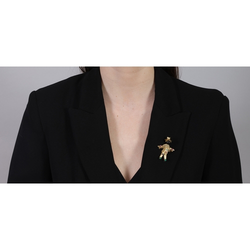 79 - A GEM-SET NOVELTY BROOCH  The stylised textured gold scarecrow with onyx head, accented with circula... 