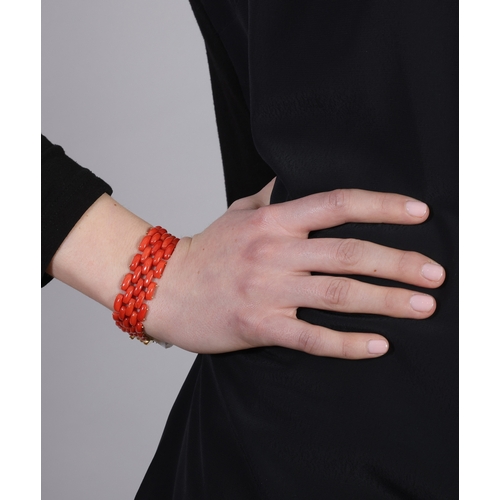 89 - A GOLD AND CORAL BRACELET  Designed as a brick-link chain bracelet, composed of polished coral, to a... 