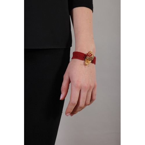 96 - AN AGATE, RUBY AND DIAMOND BRACELET  Composed of six strands of graduated red agate beads, to a clas... 