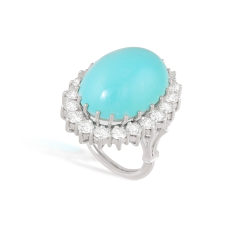 100 - A TURQUOISE AND DIAMOND CLUSTER RING  The oval-shaped turquoise cabochon weighing approximately 40.0... 