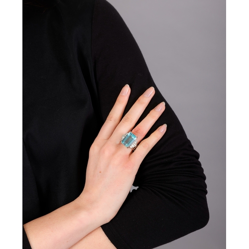 104 - A FINE AQUAMARINE AND DIAMOND RING, FRENCH, CIRCA 1960  The raised and elongated rectangular-cut aqu... 