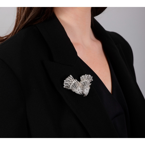 107 - A MID-20TH CENTURY DIAMOND DOUBLE CLIP BROOCH, FRENCH, CIRCA 1955  Of cornucopia design, the two mot... 
