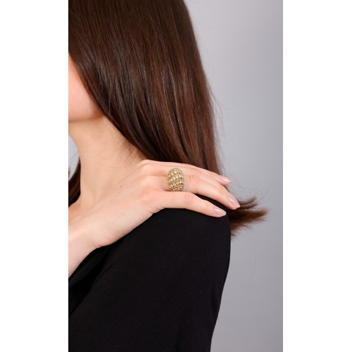 118 - A DIAMOND RING  Of openwork bombé design, set with a series of brilliant-cut diamonds between ropetw... 