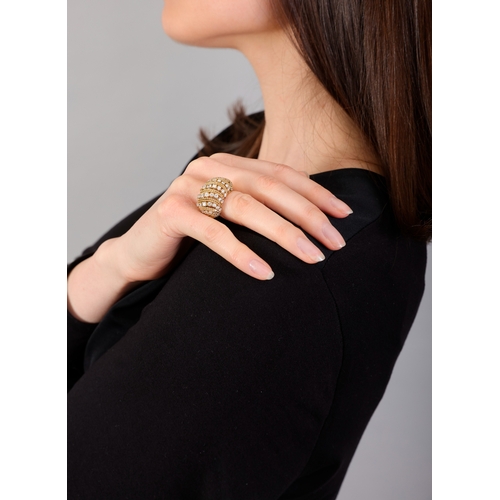 118 - A DIAMOND RING  Of openwork bombé design, set with a series of brilliant-cut diamonds between ropetw... 
