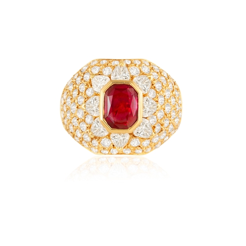 119 - A RUBY AND DIAMOND DRESS RING  The collet-set cut-cornered rectangular ruby, within a bombé mount, s... 