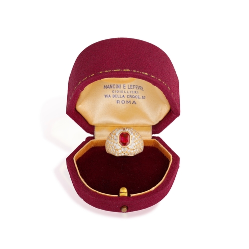 119 - A RUBY AND DIAMOND DRESS RING  The collet-set cut-cornered rectangular ruby, within a bombé mount, s... 
