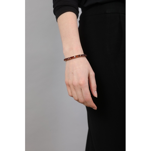 72 - TIFFANY & CO.: A RETRO CITRINE LINE BRACELET, CIRCA 1940  Of articulated design, the continuous row ... 