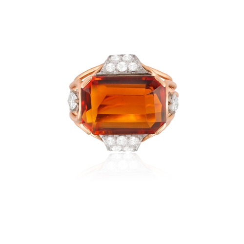 74 - A CITRINE AND DIAMOND DRESS RING, CIRCA 1950  Set horizontally, the cut-cornered rectangular citrine... 