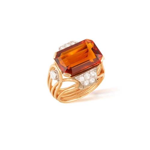 74 - A CITRINE AND DIAMOND DRESS RING, CIRCA 1950  Set horizontally, the cut-cornered rectangular citrine... 