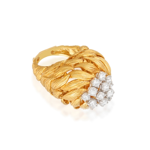 81 - A GOLD AND DIAMOND COCKTAIL RING   The openwork raised mount composed of scrolled textured leaf-shap... 