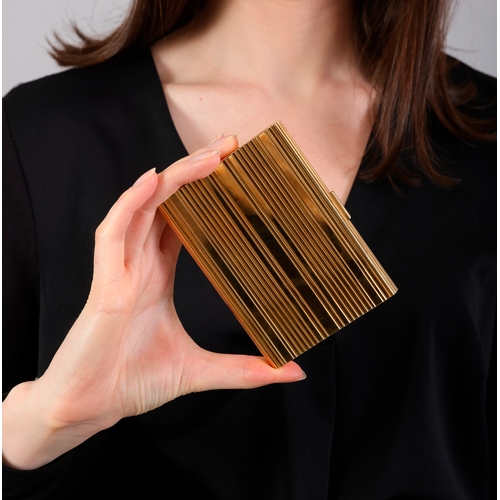 82 - HAST: A MID-20TH CENTURY GOLD CIGARETTE CASE  Of large rectangular form, all-over reeded decoration ... 