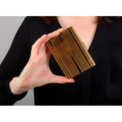 82 - HAST: A MID-20TH CENTURY GOLD CIGARETTE CASE  Of large rectangular form, all-over reeded decoration ... 