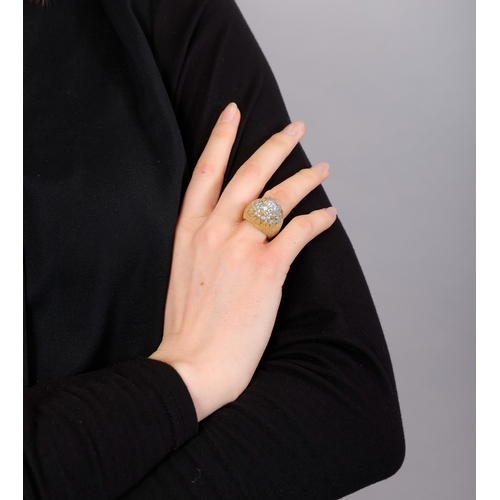 84 - A DIAMOND COCKTAIL RING   The bi-coloured mount of arched domed design, pavé-set with brilliant-cut ... 