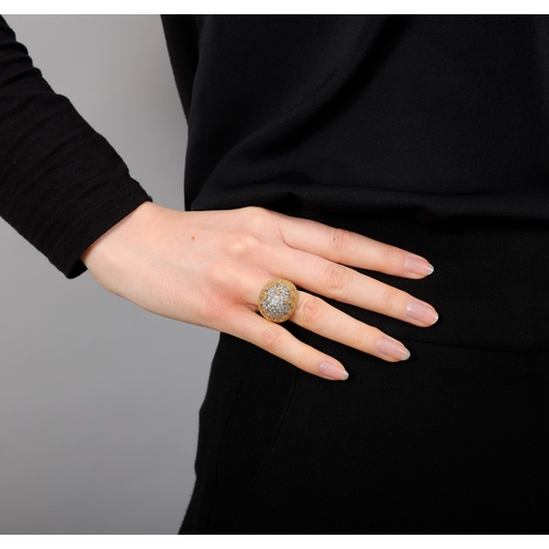 84 - A DIAMOND COCKTAIL RING   The bi-coloured mount of arched domed design, pavé-set with brilliant-cut ... 