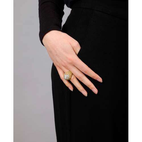 84 - A DIAMOND COCKTAIL RING   The bi-coloured mount of arched domed design, pavé-set with brilliant-cut ... 