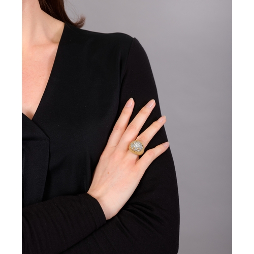 84 - A DIAMOND COCKTAIL RING   The bi-coloured mount of arched domed design, pavé-set with brilliant-cut ... 