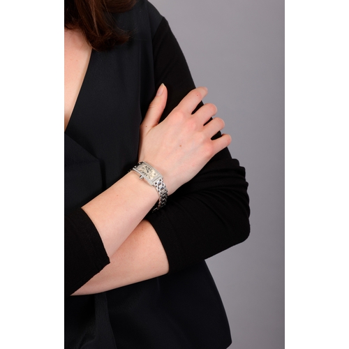 87 - CARTIER: A LADY'S 18K GOLD AND DIAMOND-SET 'TANK AMÉRICAINE' BRACELET WATCH  The 4-jewel Cal-157 qua... 