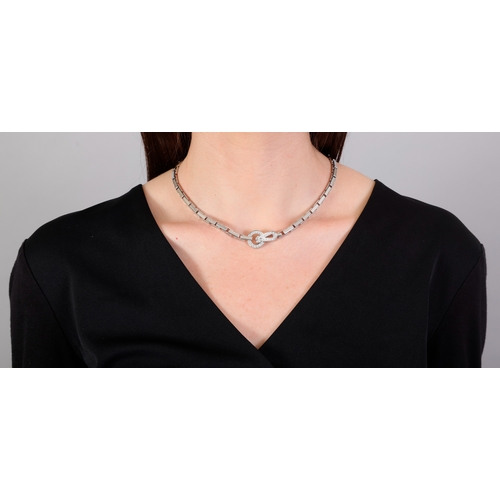 88 - CARTIER: A DIAMOND 'AGRAFE' NECKLACE  Composed of a fancy-link chain, centring a hook-and-loop clasp... 