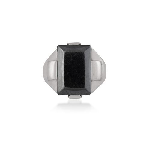 89 - A HEMATITE AND SILVER RING, CIRCA 1940  Composed of a rectangular-shaped polished hematite, set betw... 
