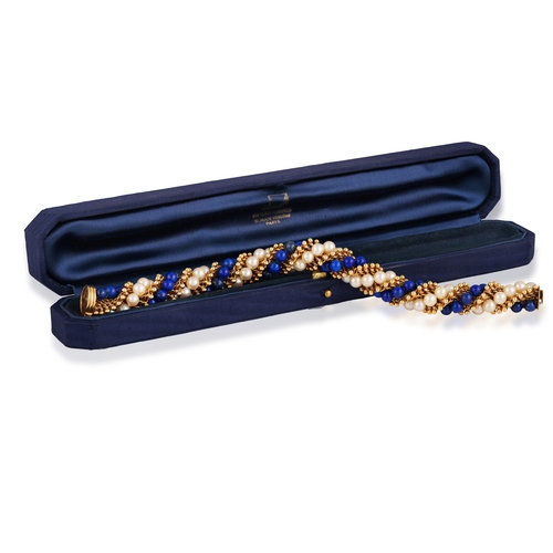 96 - VAN CLEEF & ARPELS: A LAPIS LAZULI, CULTURED PEARL AND GOLD 'TWIST' BRACELET, CIRCA 1965  Of twist r... 