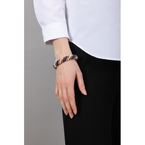 96 - VAN CLEEF & ARPELS: A LAPIS LAZULI, CULTURED PEARL AND GOLD 'TWIST' BRACELET, CIRCA 1965  Of twist r... 