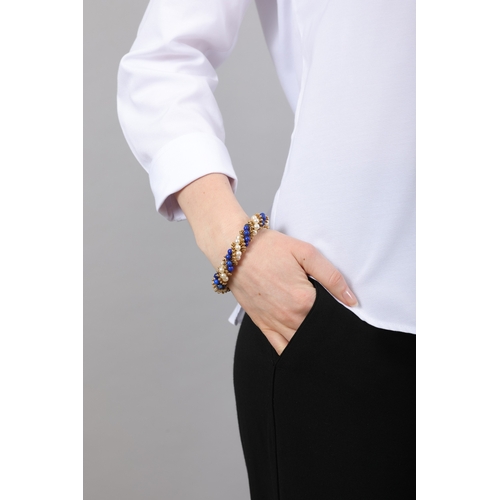 96 - VAN CLEEF & ARPELS: A LAPIS LAZULI, CULTURED PEARL AND GOLD 'TWIST' BRACELET, CIRCA 1965  Of twist r... 