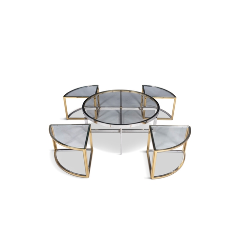 103 - TABLE  A gilt metal and chrome circular glass-topped coffee table with a nest of four tables. Italy,... 
